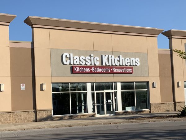 Exterior of our retail showroom with a sign reading "Classic Kitchens," advertising kitchens, bathrooms, and renovations.