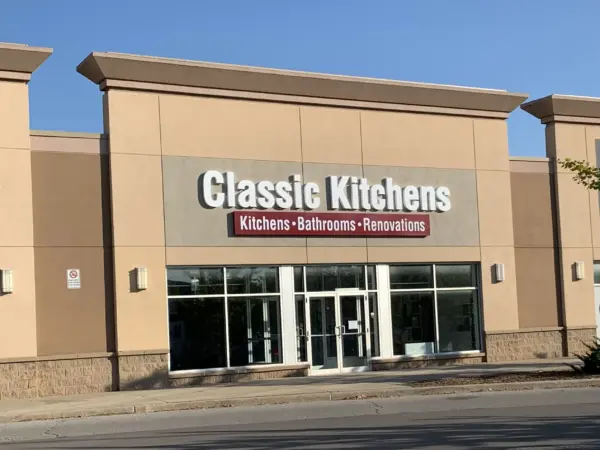 Exterior of our retail showroom with a sign reading "Classic Kitchens," advertising kitchens, bathrooms, and renovations.