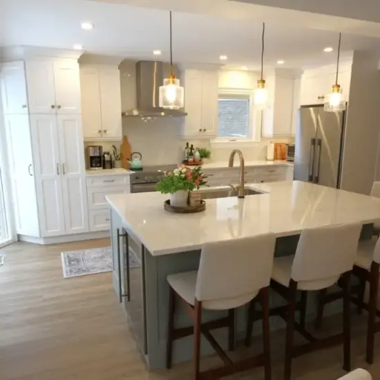 Bright modern kitchen with white cabinets, a large island, pendant lights, and four bar stools