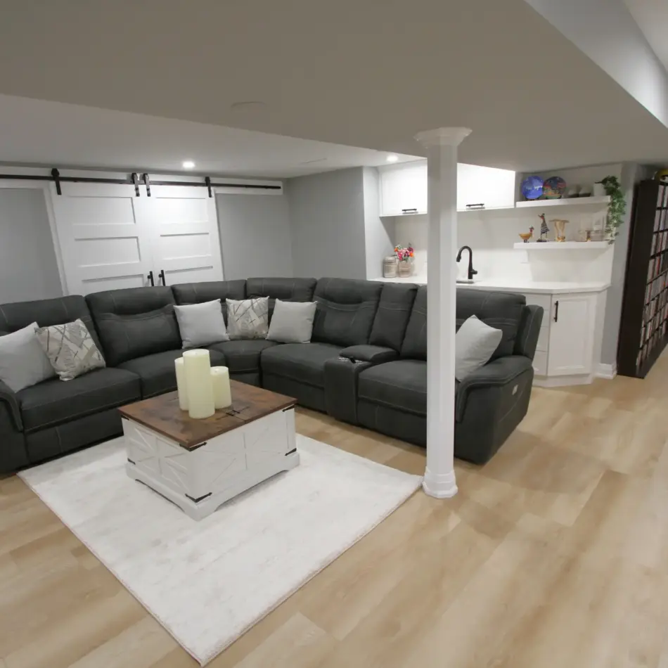 IMG_3933 Modern basement lounge with a black sectional, white coffee table, and built-in wet bar