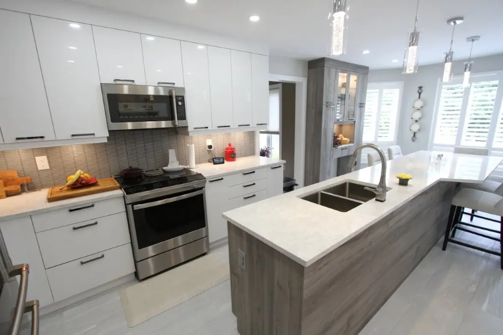 Bright modern kitchen with white cabinets, stainless appliances, and a large island with sink and seating